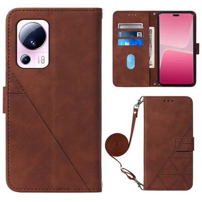 Brown leather crossbody flip phone case with 3D embossed pattern and wrist strap