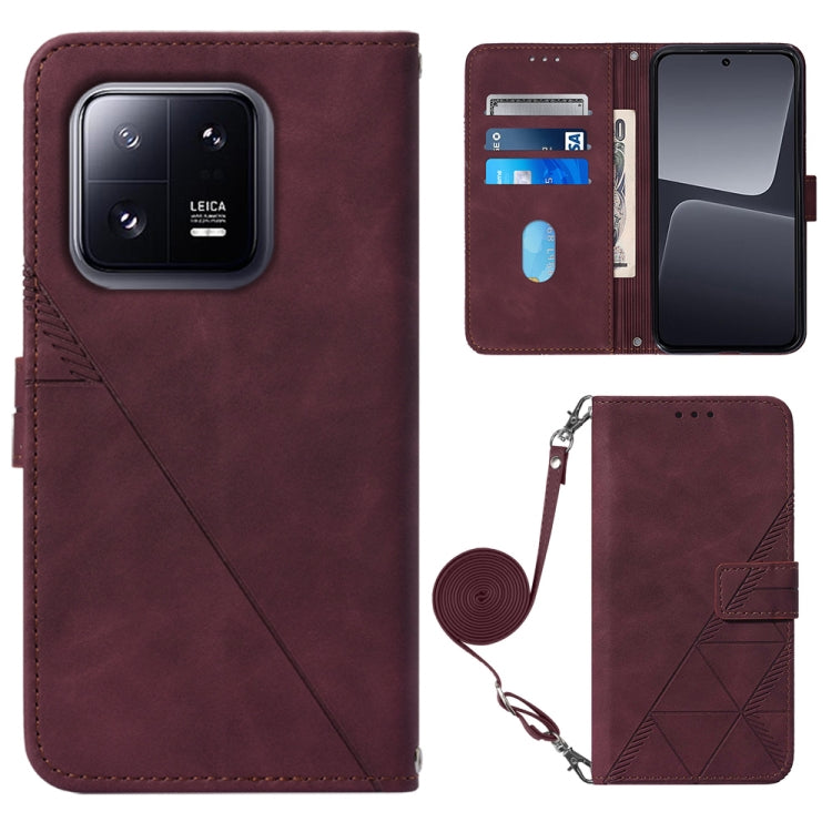 Burgundy leather crossbody flip phone case with 3D embossed pattern and wrist strap