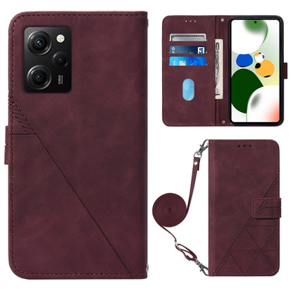 Wine red crossbody flip leather phone case with diagonal seam, magnetic clasp, and strap holder