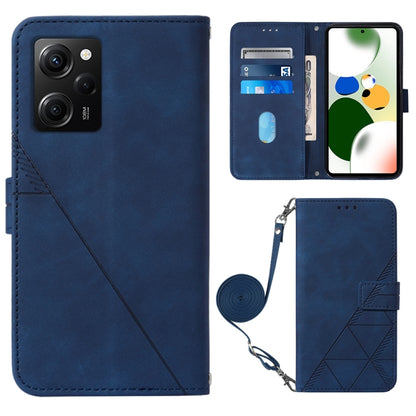 Dark blue crossbody flip leather phone case with diagonal seam, magnetic clasp, and wrist strap