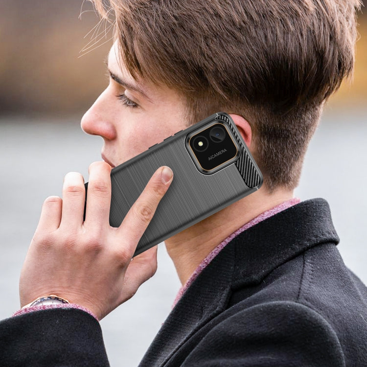 Black brushed TPU phone case on a phone with camera module cutout; carbon fiber accent