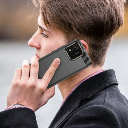Black brushed TPU phone case on a phone with camera module cutout; carbon fiber accent