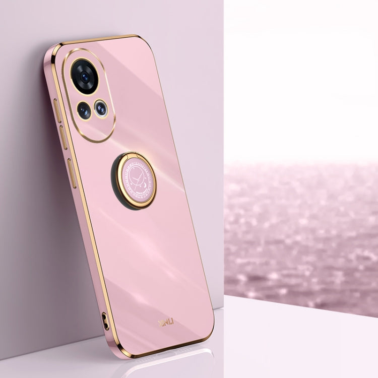 Pink TPU phone case with ring holder and gold-tone edge accents.