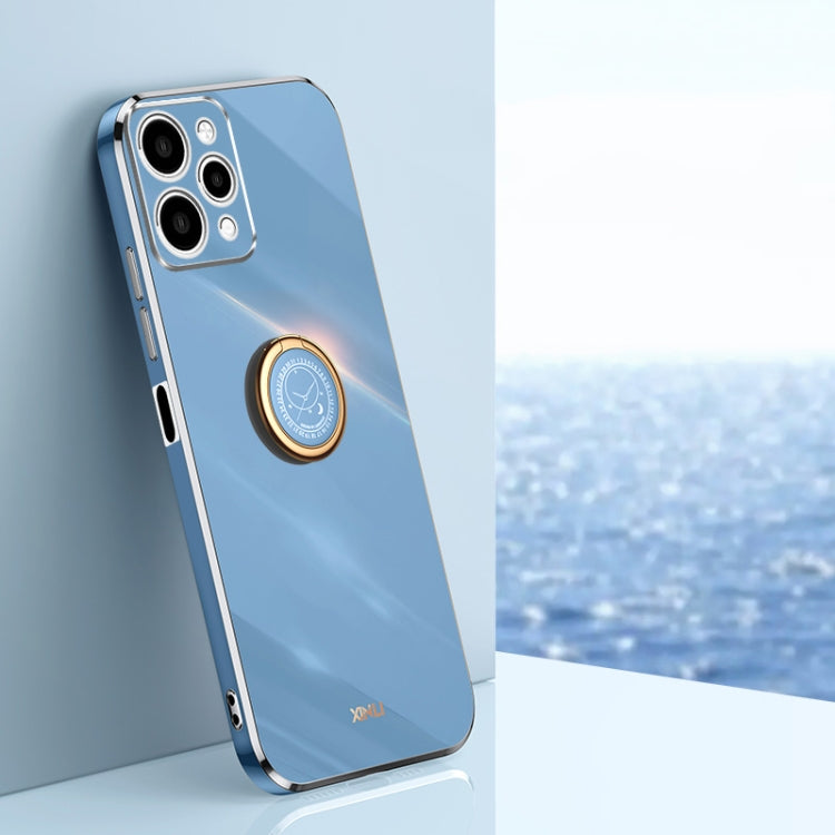 Light blue TPU phone case with ring holder and gold-tone edges, with camera cutouts