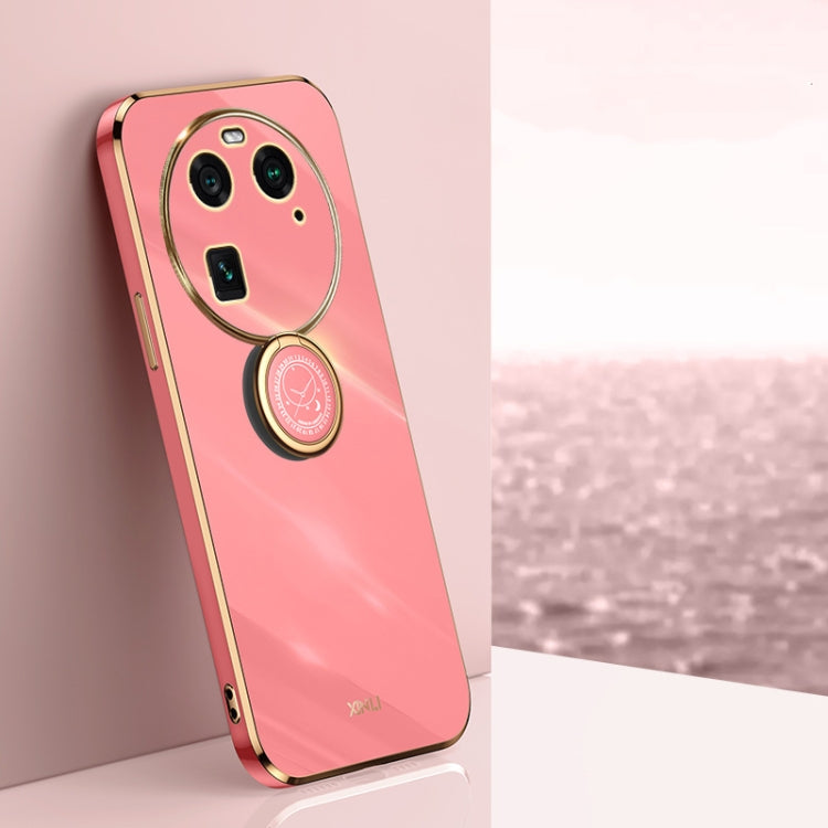 Pink TPU phone case with gold ring holder, oval lens frame, and camera cutouts