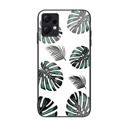 Glass phone case with black and green monstera leaf pattern on white
