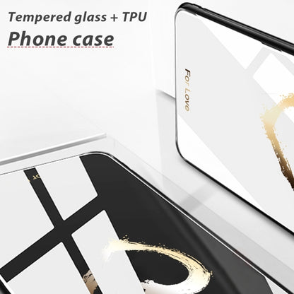 White glass phone case with black painted graphic and gold heart splash near corner