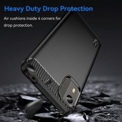 Brushed carbon fiber TPU phone case, dark black, angled close-up with camera area