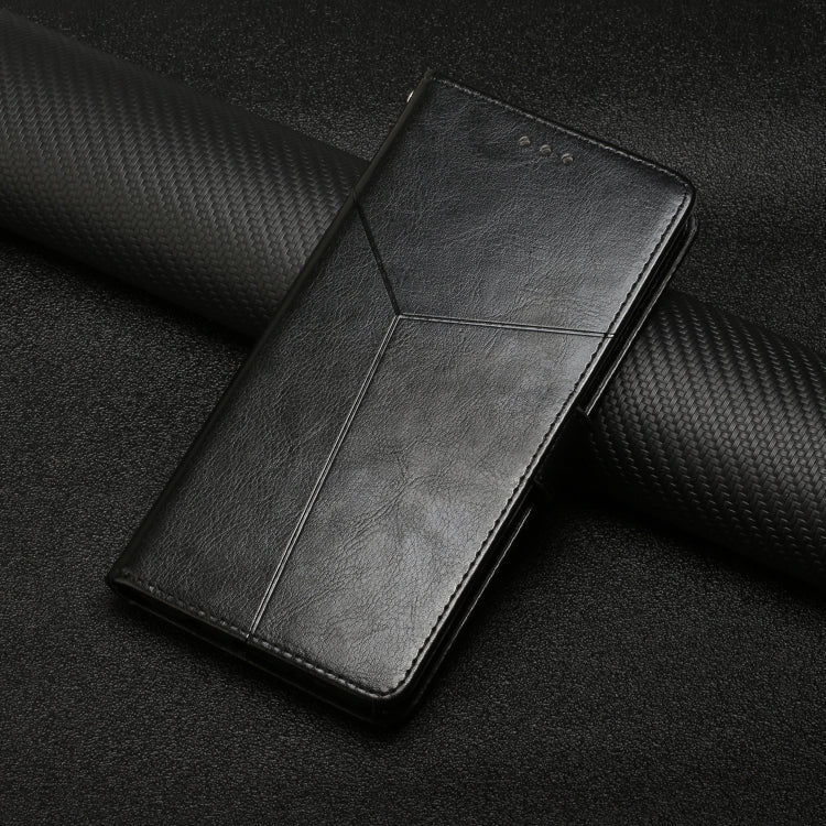 Black flip leather phone case lying on a textured surface, showing Y-shaped seam.