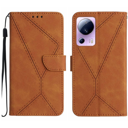 Brown embossed leather phone case with stitching pattern and camera cutout, wrist strap loop