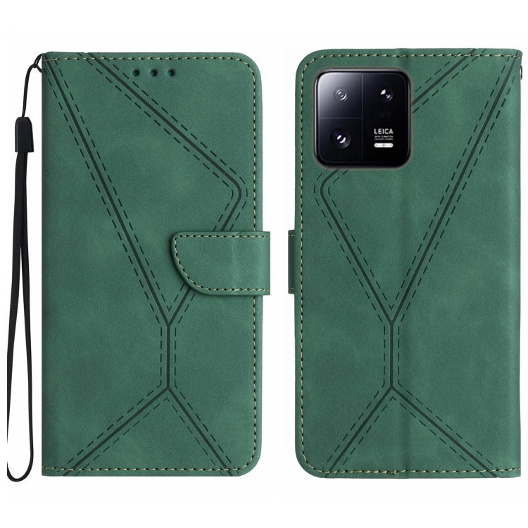 Green embossed leather phone case with flip cover, stitched pattern and wrist strap.