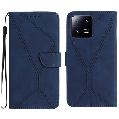 Blue embossed leather phone case with flip cover, stitched pattern and wrist strap.