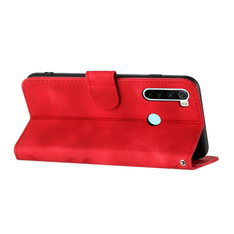 Red leather-style flip phone case with line pattern, side button cutouts, wrist strap