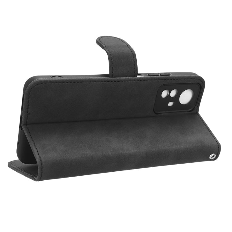 Black leather flip phone case with built-in stand and camera cutout