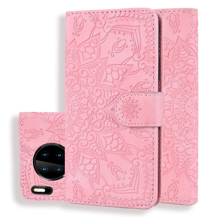 Pink embossed sunflower flip wallet case with front phone camera visible and center strap