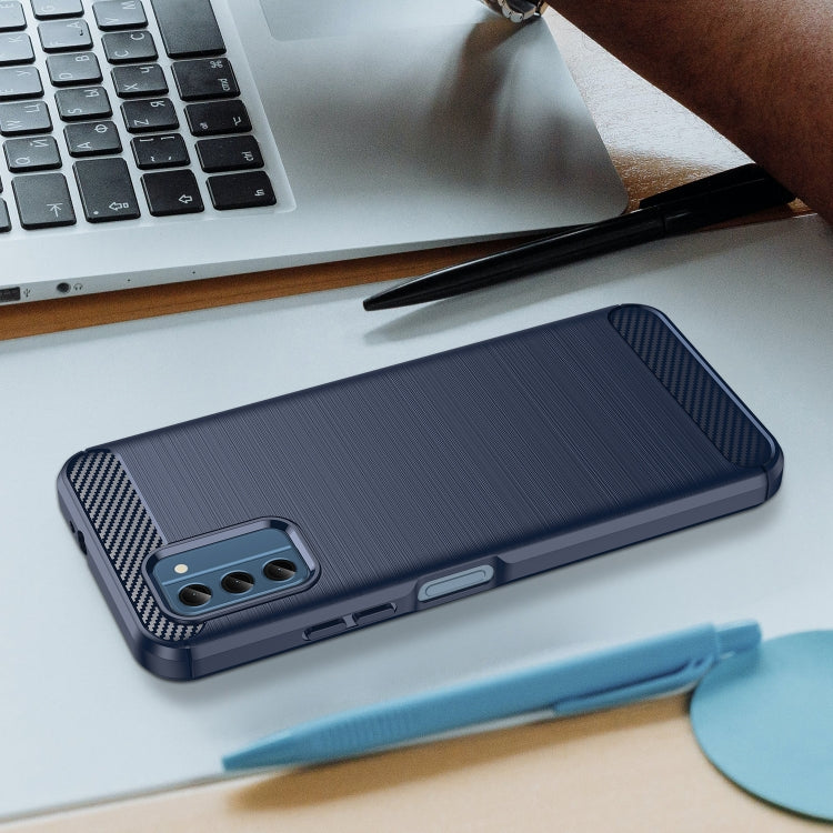 Blue textured TPU phone case lying on desk, showing side button openings and camera cutout