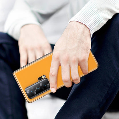 Yellow leather folding phone case in hand with camera cutout visible