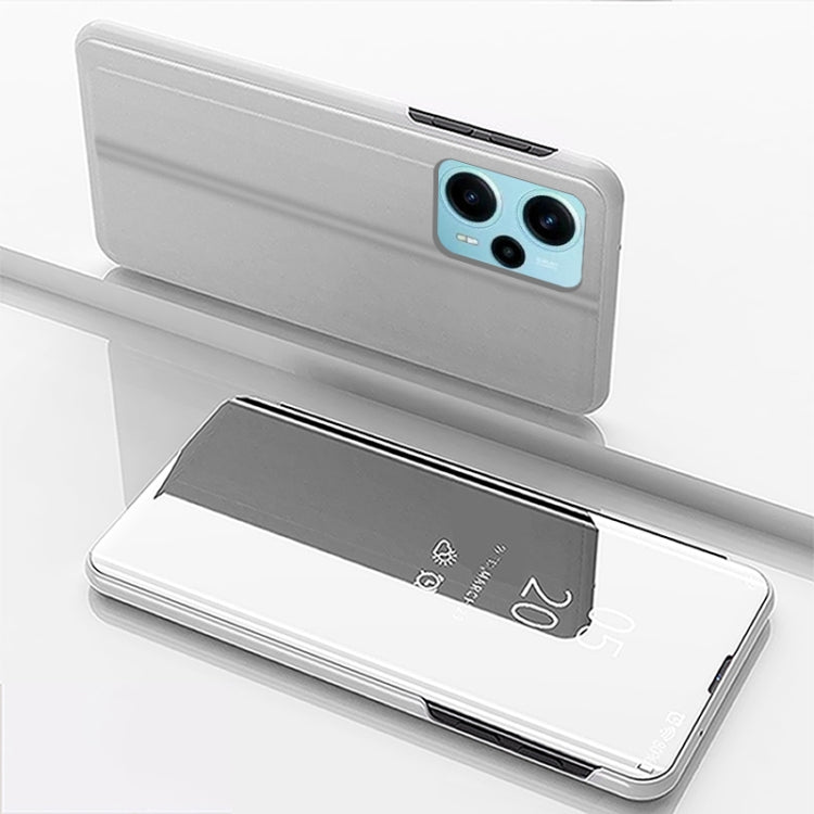 Silver flip phone case with mirror kickstand, leather-style, with camera cutouts.