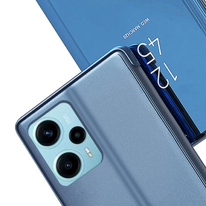 Blue flip phone case with mirror kickstand, leather-style, textured back with triple camera cutout.