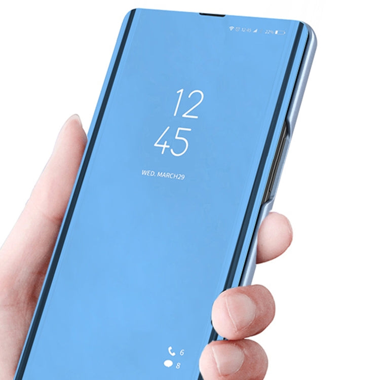 Blue flip phone case with mirror kickstand, leather-style, front cover folded out.
