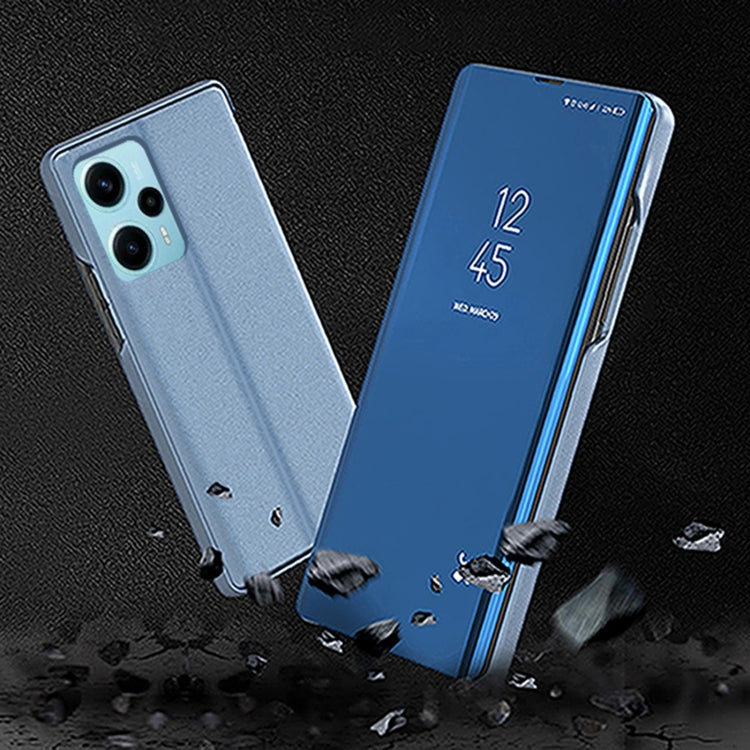 Two blue plated flip phone cases with mirror kickstand, leather-style, on textured surface.