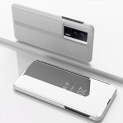Silver flip phone case with mirror kickstand, leather-style, back camera window.