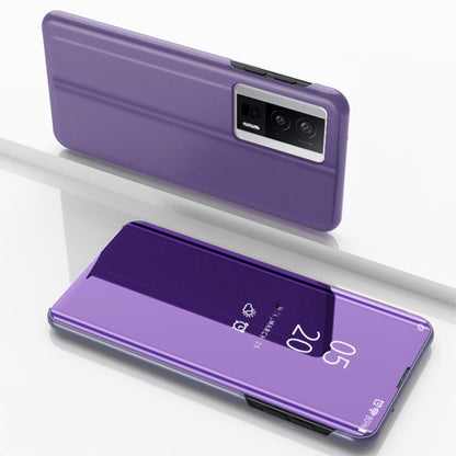 Purple flip phone case with mirror kickstand, leather-style, closed-back view.