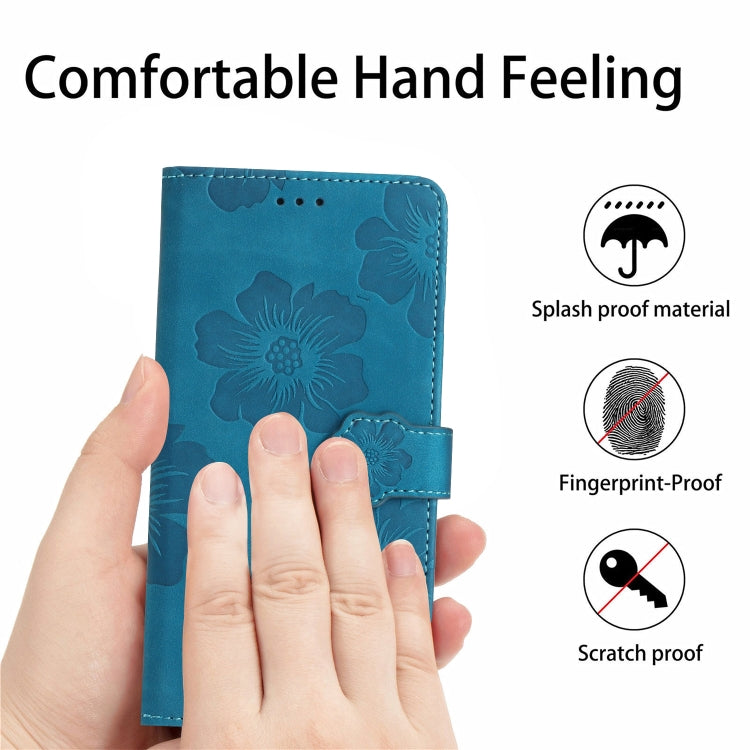 Blue embossed flower leather phone wallet case held in hand with magnetic flap