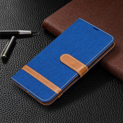 Blue denim wallet phone case with brown stitched border and magnetic flap