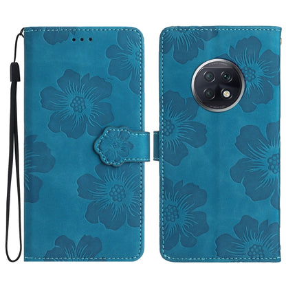 Blue leather flip phone case with embossed floral pattern and wrist strap