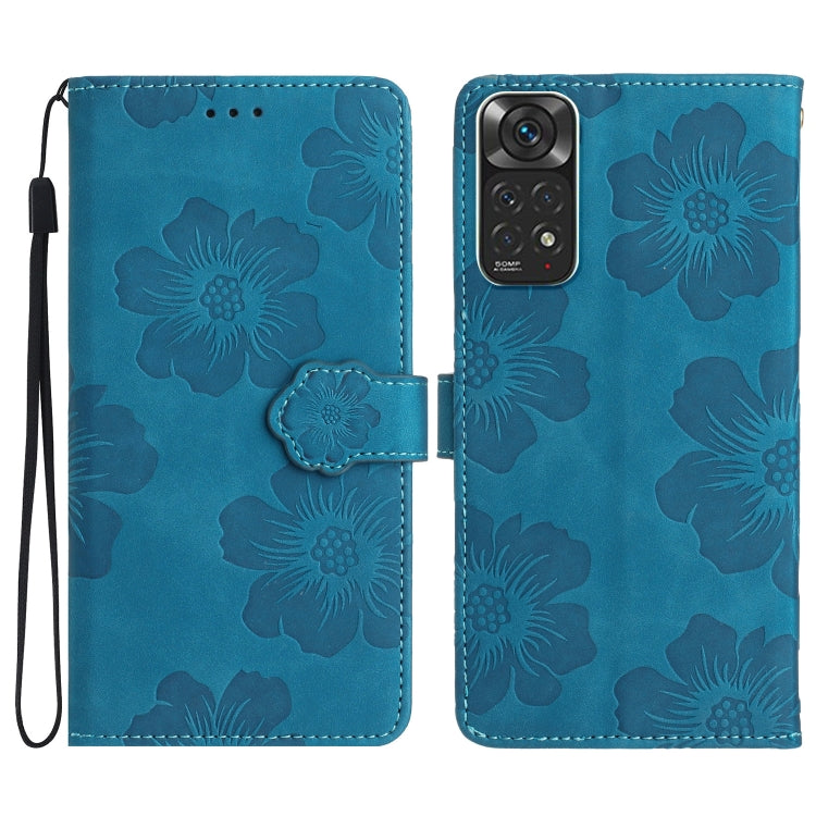 Blue embossed leather phone case with floral pattern, magnetic flap and wrist strap.