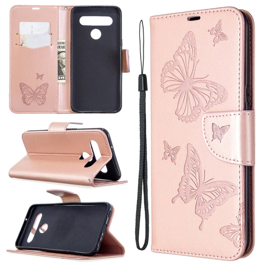 Pink leather-style phone wallet case with embossed butterflies, card slots, and wrist strap