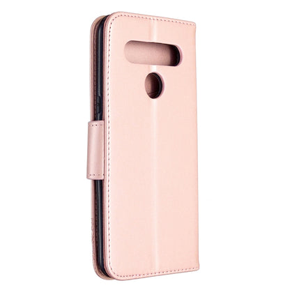 Pink leather-style phone case with embossed butterfly pattern and camera/port openings