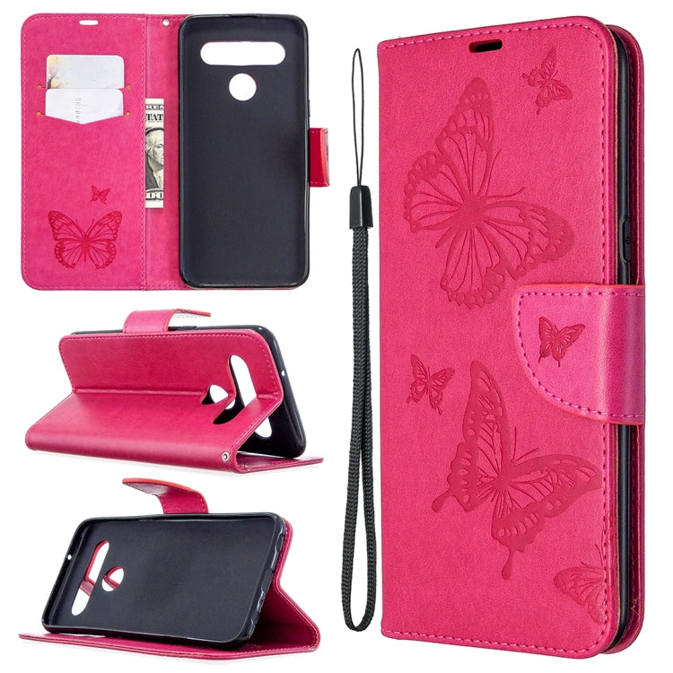 Pink leather-style phone wallet case with embossed butterflies, card slots, and wrist strap