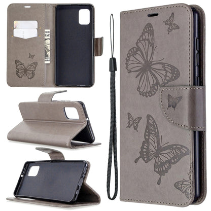 Taupe phone wallet case with butterfly emboss, flip stand, card slot, wrist strap.
