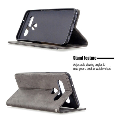 Grey flip wallet phone case with stand for angled viewing and side grip cutout
