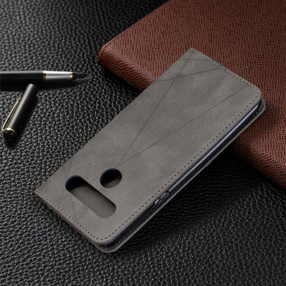 Grey flip phone wallet case with rhombus texture and front cutouts in the cover