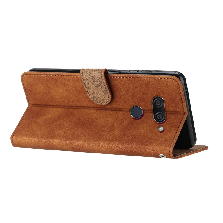Brown folio-style phone case with embossed butterfly detailing and side camera opening.