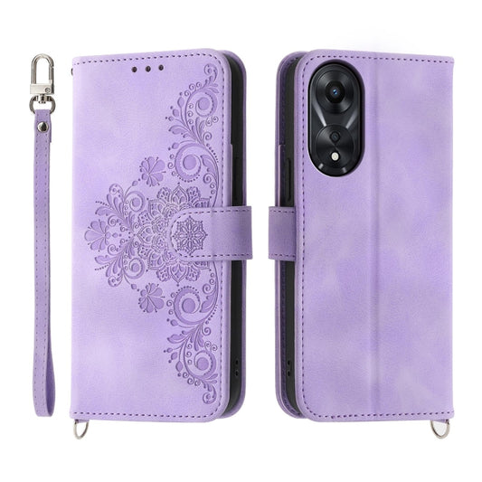 Purple embossed floral leather wallet phone case with flip cover and wrist strap.