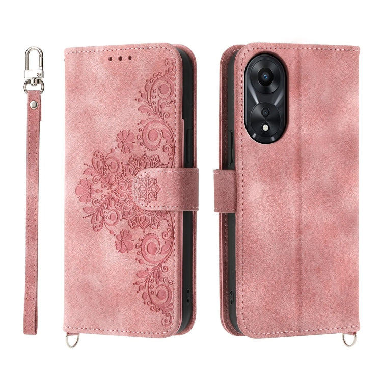Pink embossed floral leather wallet phone case with flip cover and wrist strap.