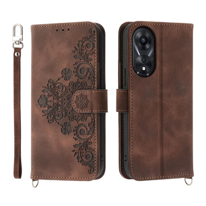 Brown embossed floral leather wallet phone case with flip cover and wrist strap.