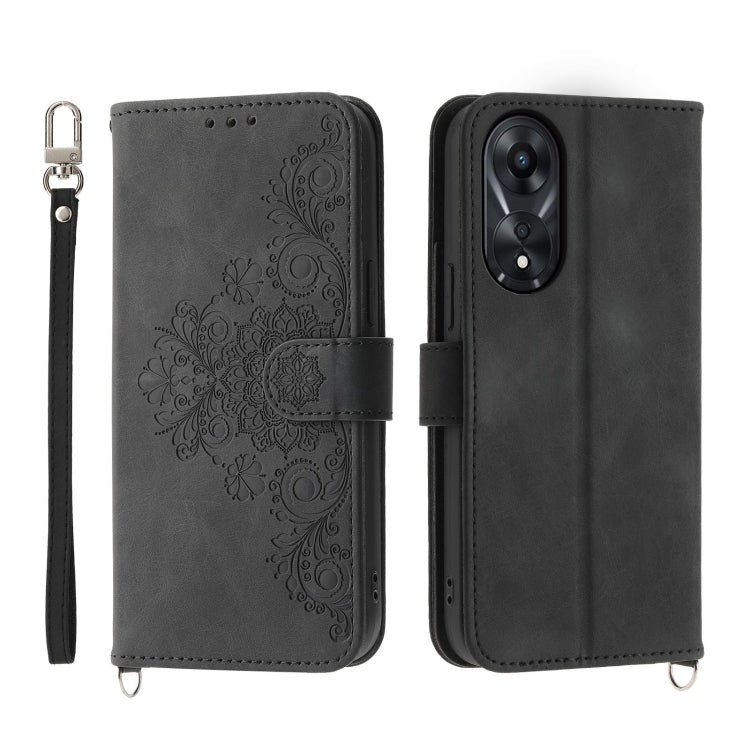 Dark gray embossed floral leather wallet phone case with flip cover and wrist strap.