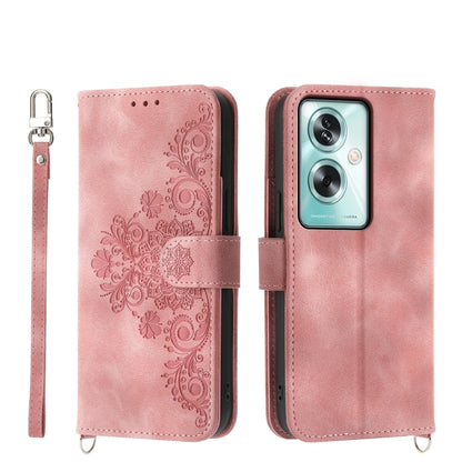 Pink leather phone wallet case with embossed floral design, camera cutout, strap