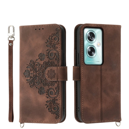 Brown leather phone wallet case with embossed floral design, camera cutout, strap