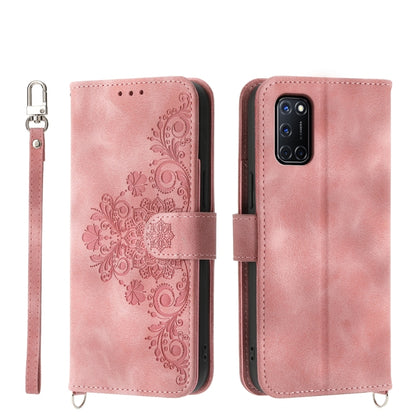 Pink leather phone wallet case with embossed floral design and wrist strap
