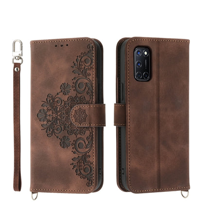 Brown leather phone wallet case with embossed floral design and wrist strap
