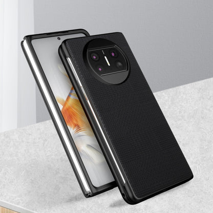 Black shockproof phone case with textured back and raised quad camera cutout