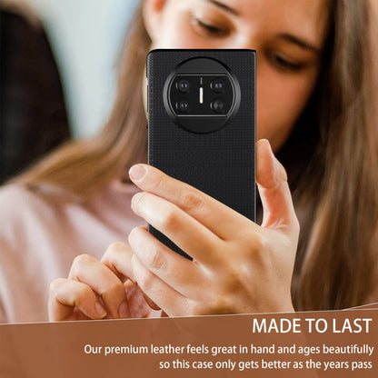 Black shockproof phone case with textured back and raised quad camera cutout in hand