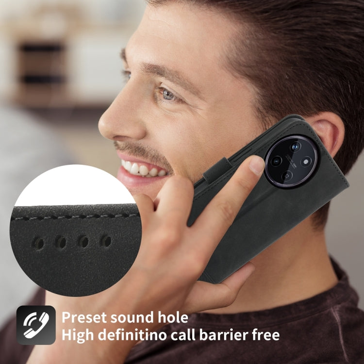 Black folio wallet phone case with wrist strap and speaker/sound cutout near top.