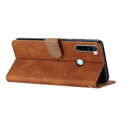 Brown leather folio phone case with foldover flap and butterfly embossing, wrist strap